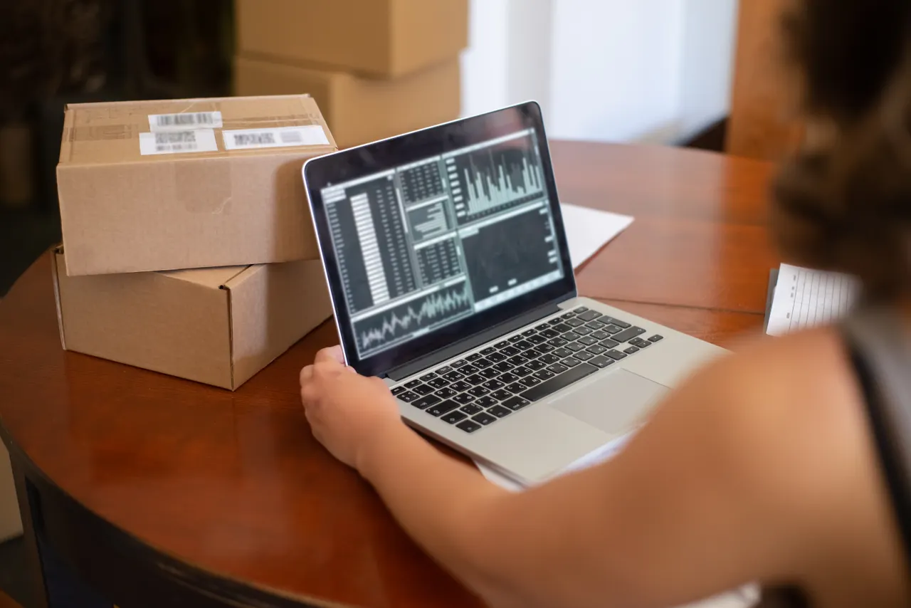 Small business owner managing online orders on a laptop