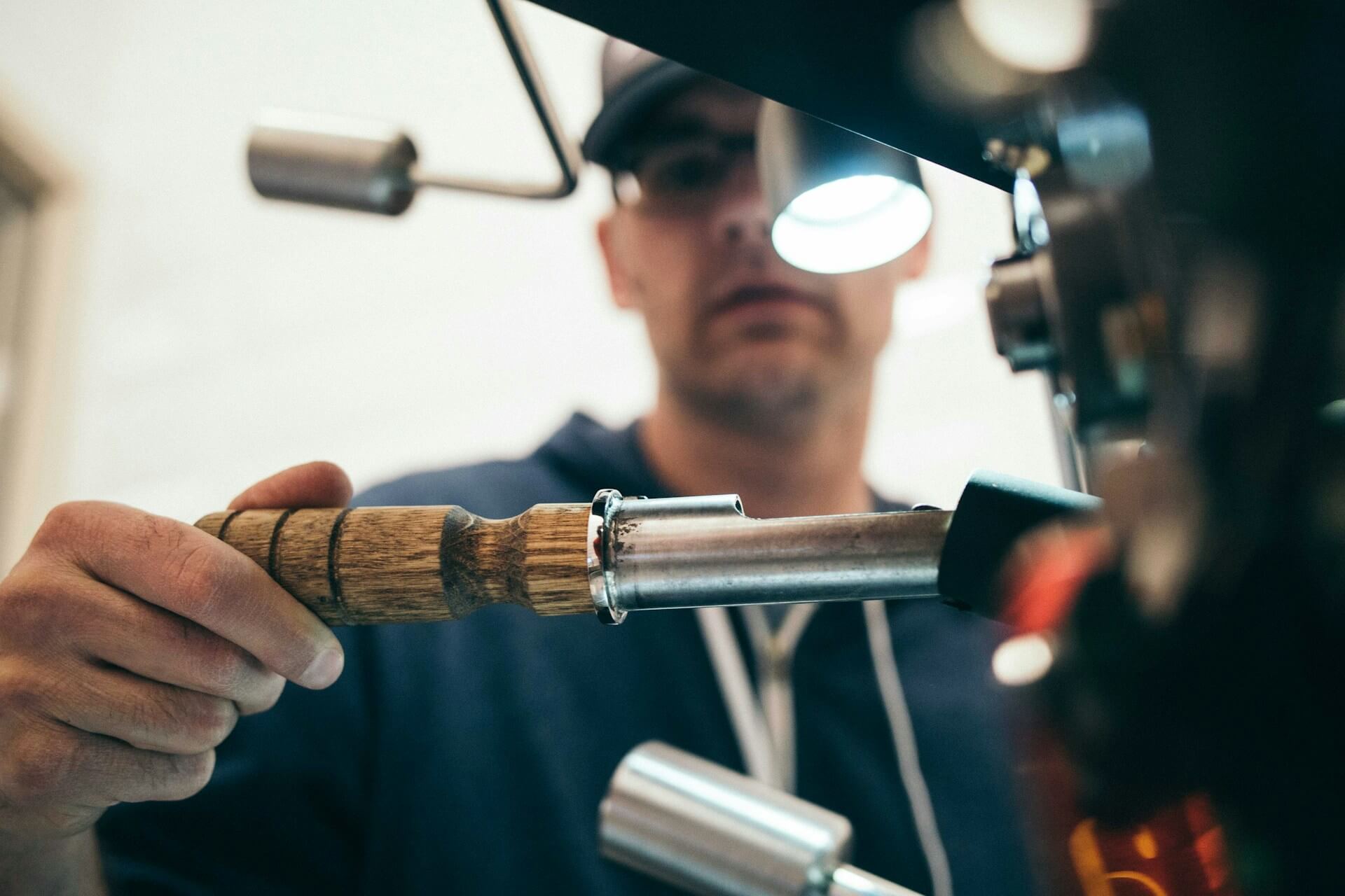 Plumber working on a pipe under a sink